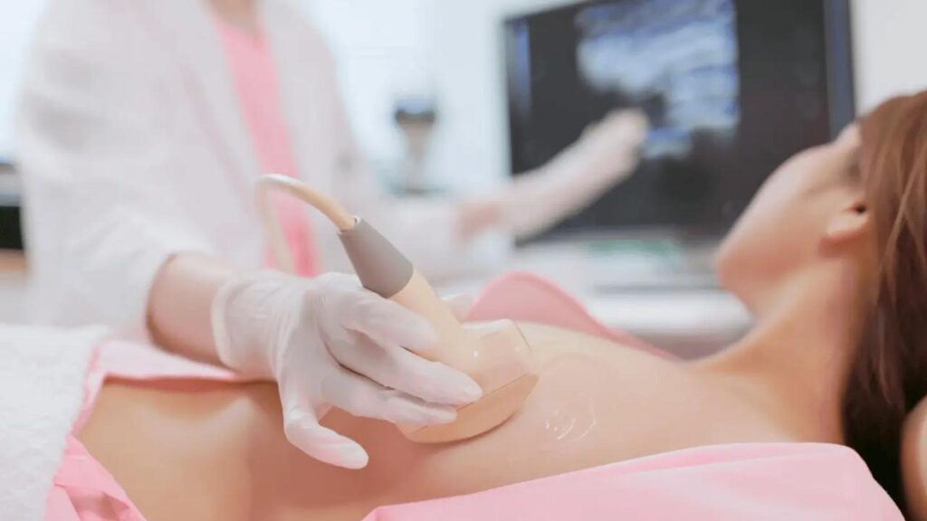 Breast ultrasound procedure in Dubai showing a radiologist using ultrasound to examine breast tissue for cancer screening.