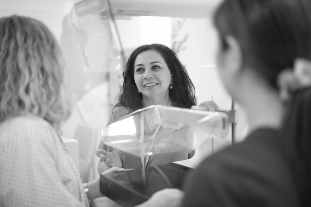 Dr. Norran Hussein, Breast Imaging Specialist in Dubai, consulting patients during a mammogram procedure for breast cancer screening.