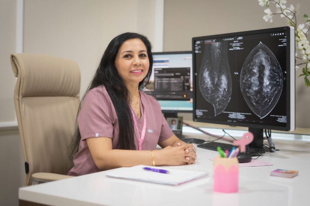 Dr. Norran Hussein, Breast Imaging & Intervention Radiologist in Dubai, reviewing mammogram results at her clinic.