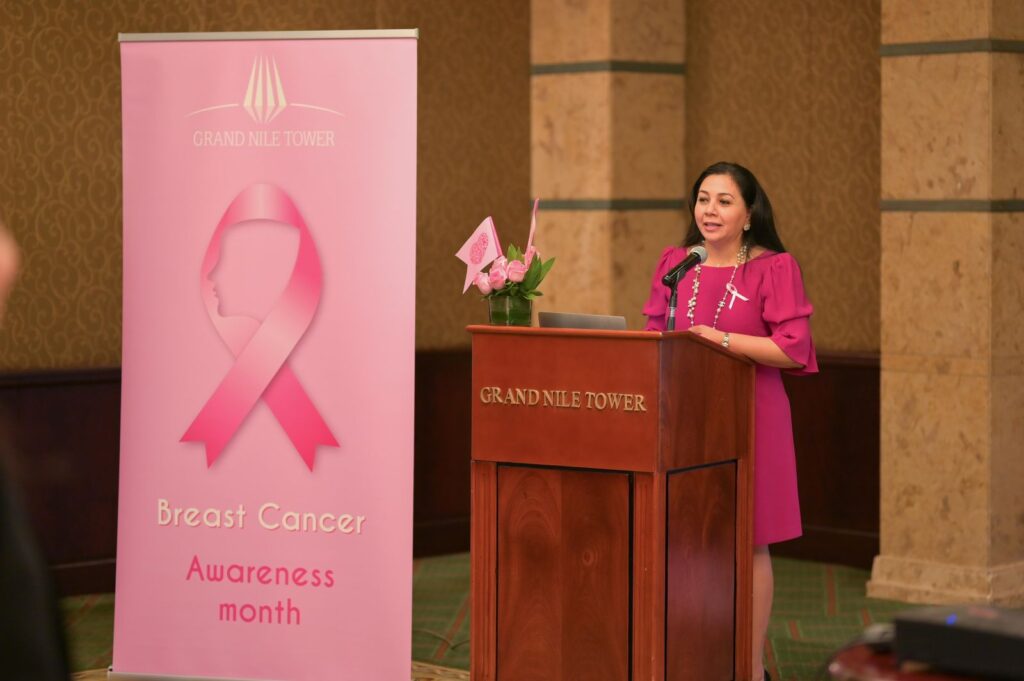Dr. Norran Hussein speaking at a Breast Cancer Awareness Month event in Dubai, highlighting the importance of breast imaging and early detection.